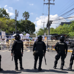 Policías aguardan en el portón sur de la Asamblea Legislativa, por marcha de ambientalistas que exigen derogar la Ley de Recursos Hídricos.
